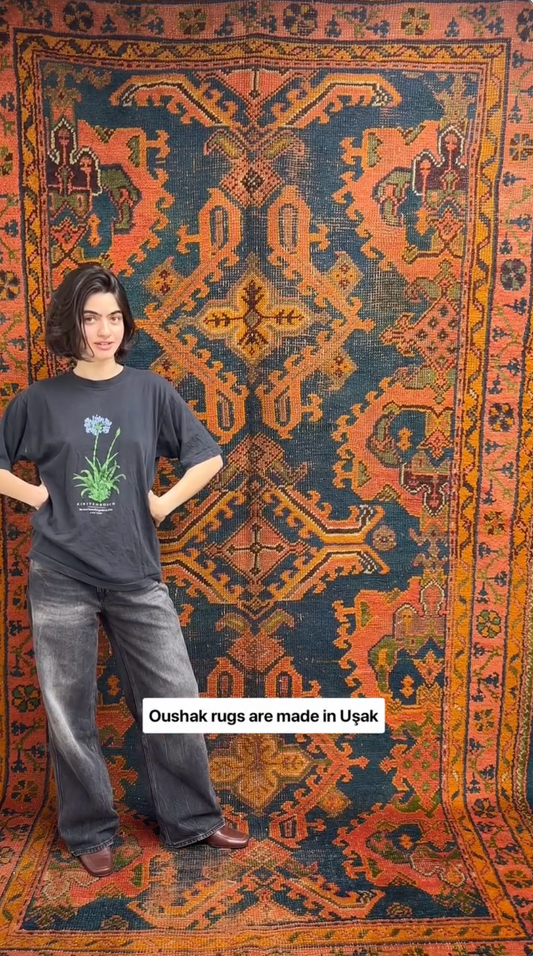Person standing in front of a large Oushak rug with text about rug production.